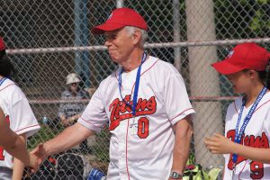 PHOTO COURTESY ERIC STICKNEY  REMEMBERING A COACH, TEACHER: David Stickney, seen here at a York Mills CI softball game, died May 11 at Goulding Park. He was 71. 