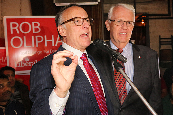 BRIAN BAKER/TOWN CRIER SPORTSMANSHIP: Liberal MP-elect Rob Oliphant addresses his supporters during his victory speech, while defeated Conservative incumbent John Carmichael looks on. Oliphant and the Liberals cruised to victory in Toronto during the 42nd federal election. 