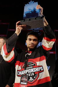 BRIAN BAKER/DORK SHELF THE CHAMP: Allameen Ally, 18, raises the Cineplex World Gaming Canadian Championships trophy high above his head, March 7.